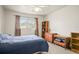 Comfortable bedroom features a ceiling fan, window and carpeted floor at 230 Portree Dr, Dunedin, FL 34698