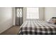 Bedroom featuring a bed, door to the exterior, and a window at 230 Portree Dr, Dunedin, FL 34698