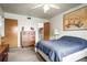 Cozy bedroom with soft carpet, a comfortable bed, and classic furniture under a ceiling fan at 230 Portree Dr, Dunedin, FL 34698
