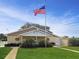 Charming building with manicured lawn, lush landscaping, and clear blue skies at 230 Portree Dr, Dunedin, FL 34698
