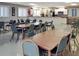 Bright clubhouse featuring multiple tables, chairs, and a well-equipped kitchenette at 230 Portree Dr, Dunedin, FL 34698