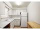 Kitchen features white cabinets, tile flooring and white appliances at 230 Portree Dr, Dunedin, FL 34698