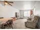 Comfortable living space featuring cozy seating, a dining area, and classic furnishings under a ceiling fan at 230 Portree Dr, Dunedin, FL 34698