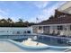 Inviting community pool surrounded by lounge chairs and lush landscaping for relaxing outdoor enjoyment at 230 Portree Dr, Dunedin, FL 34698