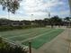 Inviting recreation area with shuffleboard courts, benches, and picturesque water views at 230 Portree Dr, Dunedin, FL 34698