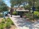 Quaint street view of shops and restaurants in downtown Dunedin, featuring a dolphin statue landmark at 230 Portree Dr, Dunedin, FL 34698