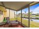 The screened patio offers serene water views at 230 Portree Dr, Dunedin, FL 34698