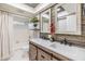 Bathroom with double sink vanity, wood accent wall, and shower/tub combo at 2724 Ashwood Ct, Clearwater, FL 33761
