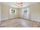 Bedroom with hardwood floors, ceiling fan, and natural light from dual windows at 2724 Ashwood Ct, Clearwater, FL 33761