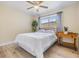 Bright bedroom with wood floors, ceiling fan, and a large window with natural light at 2724 Ashwood Ct, Clearwater, FL 33761
