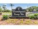 Countryside Country Club sign with flowering plants and manicured landscaping at 2724 Ashwood Ct, Clearwater, FL 33761