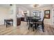 Bright dining area adjacent to the kitchen with a window and stylish lighting fixtures at 2724 Ashwood Ct, Clearwater, FL 33761