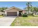 Inviting home with a well-kept lawn, two-car garage, and a decorative stone accent at 2724 Ashwood Ct, Clearwater, FL 33761