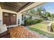Inviting front porch with wood floors, a cozy bench, and a decorative front door at 2724 Ashwood Ct, Clearwater, FL 33761