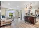 Bright living room with a large window, comfortable seating, and direct access to the kitchen and outdoor areas at 2724 Ashwood Ct, Clearwater, FL 33761