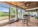 Screened-in patio with wood ceiling, fan, wood tile flooring, and outdoor seating at 2724 Ashwood Ct, Clearwater, FL 33761