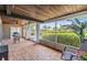 Enclosed back porch with a wood ceiling, fan, wood tile flooring and outdoor seating at 2724 Ashwood Ct, Clearwater, FL 33761