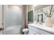Bright bathroom with white vanity, ceramic tile surround, and shower-tub combination at 29524 Zupetta Ln, Wesley Chapel, FL 33543