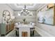 Elegant dining room featuring a modern chandelier, stylish sideboard, and beautiful abstract art at 29524 Zupetta Ln, Wesley Chapel, FL 33543