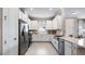 Modern kitchen with stainless steel appliances, white cabinetry, and a functional layout at 29524 Zupetta Ln, Wesley Chapel, FL 33543