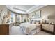 Tranquil main bedroom with neutral tones, large windows, and stylish furnishings at 29524 Zupetta Ln, Wesley Chapel, FL 33543