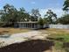 View of home from backyard, showcasing a large screened porch, landscaping, and a white privacy fence at 3000 58Th S Ave, St Petersburg, FL 33712