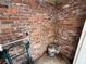 Unfinished basement area featuring exposed brick walls, offering potential for customization and additional living space at 3000 58Th S Ave, St Petersburg, FL 33712