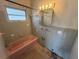 Retro bathroom features blue tile, a pink bathtub, and vintage fixtures at 3000 58Th S Ave, St Petersburg, FL 33712