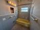 Retro bathroom showcasing blue tile, a yellow bathtub, and classic fixtures at 3000 58Th S Ave, St Petersburg, FL 33712