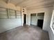 Bedroom features built-in shelving, a closet, and a window at 3000 58Th S Ave, St Petersburg, FL 33712