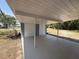 Open carport with painted concrete flooring and access to storage at 3000 58Th S Ave, St Petersburg, FL 33712