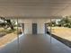 Open carport with painted concrete flooring and access to storage at 3000 58Th S Ave, St Petersburg, FL 33712