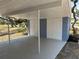 Open carport with painted concrete flooring and access to storage at 3000 58Th S Ave, St Petersburg, FL 33712