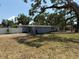 Attractive light blue house with brick accents, complemented by tidy landscaping and mature trees in the front yard at 3000 58Th S Ave, St Petersburg, FL 33712
