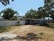 Well-maintained one-story home with a light blue facade, carport, and a neatly kept yard with mature trees at 3000 58Th S Ave, St Petersburg, FL 33712