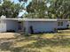 Cozy home featuring fresh landscaping with vibrant red flowers beneath the house number at 3000 58Th S Ave, St Petersburg, FL 33712