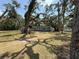 Charming single-story home with a light blue exterior and a spacious front yard shaded by mature trees at 3000 58Th S Ave, St Petersburg, FL 33712