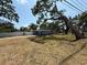 Quaint one-story home featuring a light blue exterior, set on a spacious lot with mature shade trees at 3000 58Th S Ave, St Petersburg, FL 33712