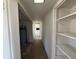 Hallway displaying a water heater, a glimpse of the fireplace, and a storage closet at 3000 58Th S Ave, St Petersburg, FL 33712