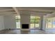 Bright living room featuring high ceilings, exposed beams, and a painted brick fireplace at 3000 58Th S Ave, St Petersburg, FL 33712