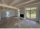 Inviting living room with a brick fireplace and ample natural light from large windows at 3000 58Th S Ave, St Petersburg, FL 33712