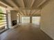 Open living room featuring a brick fireplace, white brick walls and beam ceilings at 3000 58Th S Ave, St Petersburg, FL 33712