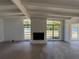 Living room with a brick fireplace and large windows, offering views of the landscaped yard at 3000 58Th S Ave, St Petersburg, FL 33712