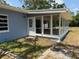 Enclosed porch with multiple windows, accessible by a side door, offers a relaxing outdoor space at 3000 58Th S Ave, St Petersburg, FL 33712