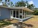 Enclosed porch with multiple windows, accessible by a side door, offers a relaxing outdoor space at 3000 58Th S Ave, St Petersburg, FL 33712