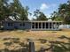 Single-story home boasting a large screened porch and backyard with mature trees, creating a peaceful outdoor space at 3000 58Th S Ave, St Petersburg, FL 33712