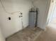Utility room featuring a water heater, exposed plumbing, and neutral walls at 3000 58Th S Ave, St Petersburg, FL 33712