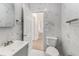 This bathroom features marble tile, a white vanity, and a door leading to another room at 3315 58Th S Ave # 605, St Petersburg, FL 33712