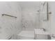 Modern bathroom with marble tile, a shower, and a white vanity at 3315 58Th S Ave # 605, St Petersburg, FL 33712