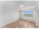 Bright bedroom featuring wood floors, a large window, and a neutral color scheme at 3315 58Th S Ave # 605, St Petersburg, FL 33712